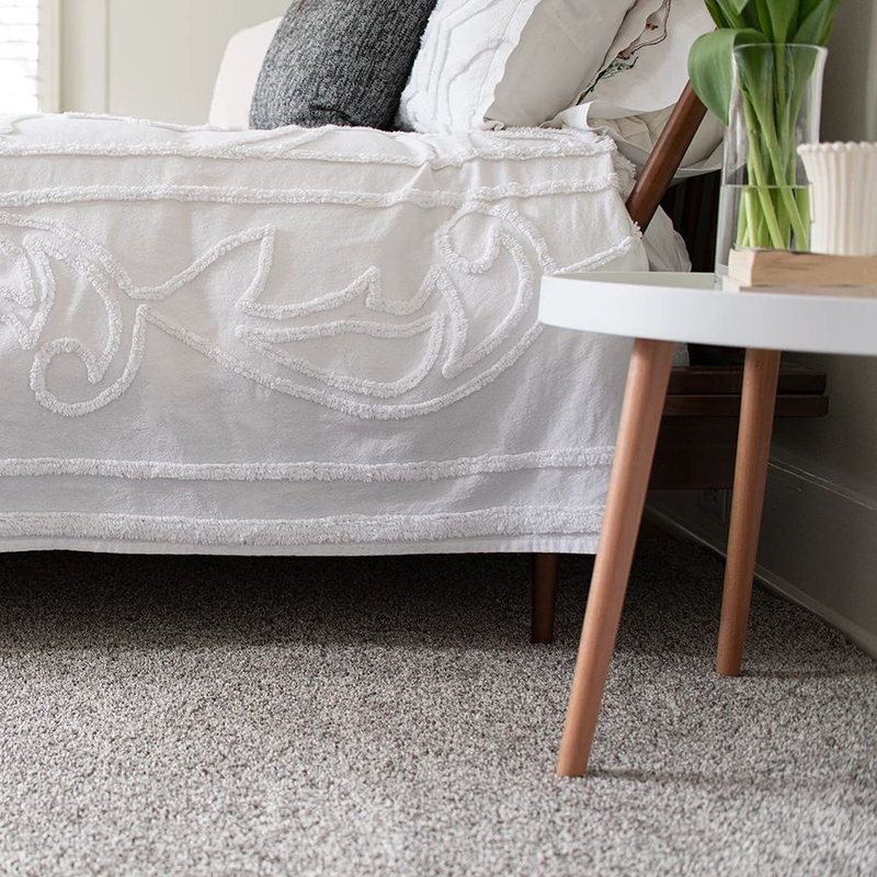 Bedroom with a white bed and gray carpet from Wilmington Carpets in the Wilmington, OH area