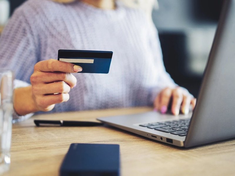 person using laptop to pay by card online at Wilmington Carpets in the Wilmington, OH area